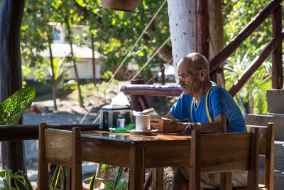 Man sitting on table at cafe