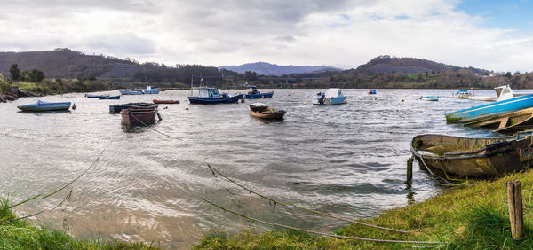 Boats moored on sea against sky