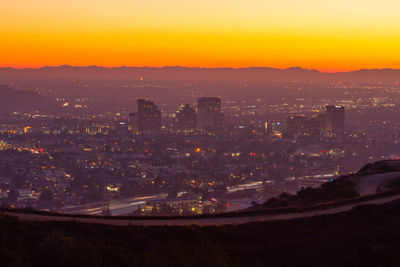 View of downtown glendale ca at sunset. fireworks can be seen in the distance.