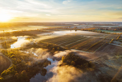 Aerial view of landscape against sky during sunrise