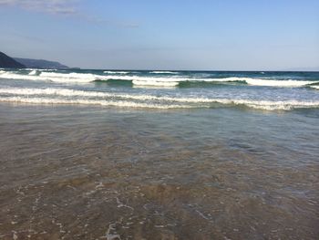 Scenic view of beach and sea against clear sky