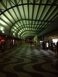 People in illuminated corridor