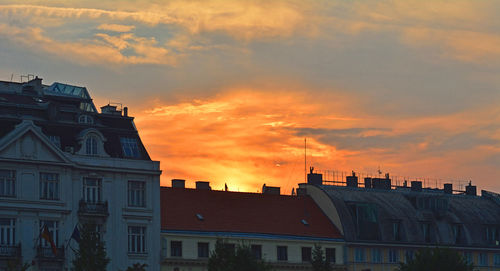 Buildings in city against cloudy sky