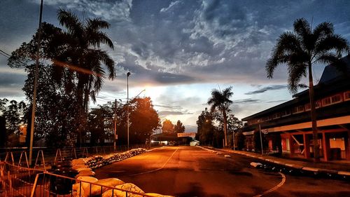 Empty road against cloudy sky