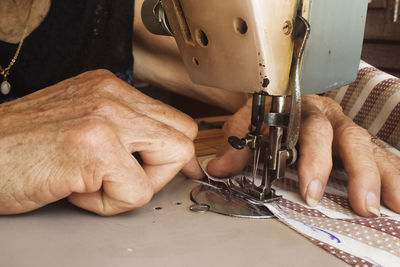 Cropped hands using sewing machine