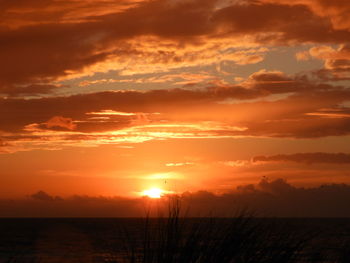 Scenic view of sea against romantic sky at sunset