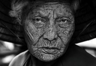 Close-up portrait of senior woman with wrinkled face