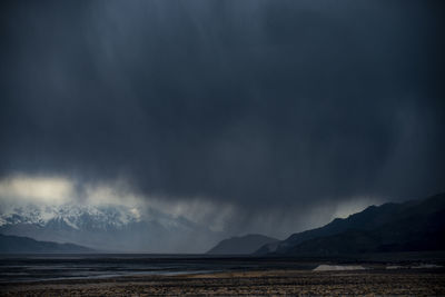 A storm passes through the badwater basin salt flats desert in d