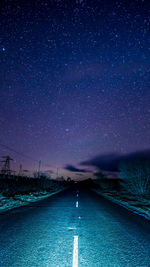 Scenic view of road against blue sky at night