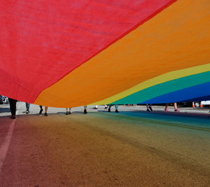 A colorful rainbow pride flag passing over the streets of ft. worth texas