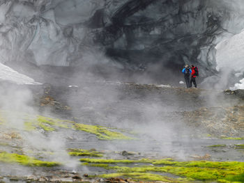 Couple exploring the glacier at hrafntinnusker in iceland