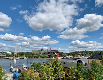 High angle view of buildings by sea against sky