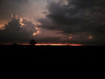 Dramatic sky over silhouette landscape during sunset