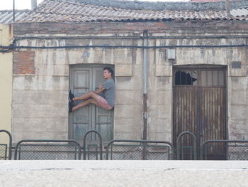 Side view of man balancing at closed door