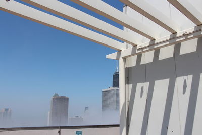 Low angle view of modern buildings against clear blue sky