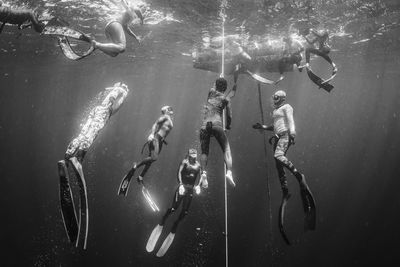 Group of people swimming in sea