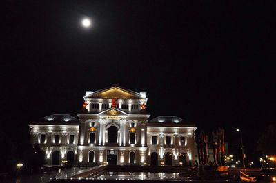 Low angle view of illuminated building against sky at night