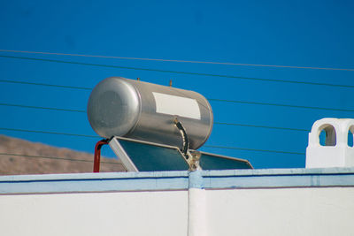 Low angle view of telephone pole against blue sky