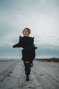 Full length of man on beach against sky