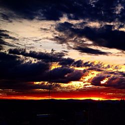 Silhouette of landscape against cloudy sky