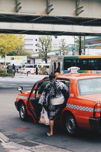 Man walking on road in city