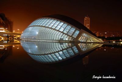 Reflection of illuminated buildings in city at night