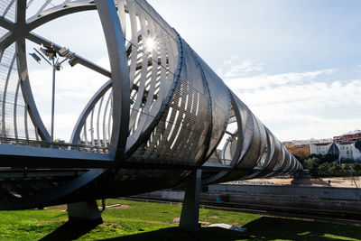 Modern metal footbridge over manzanares river in madrid.