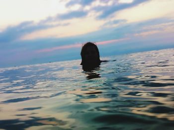 Portrait of woman swimming in sea