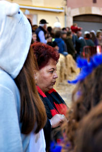 Side view of senior woman standing during event