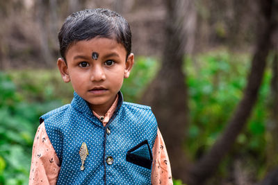 Portrait of boy standing outdoors