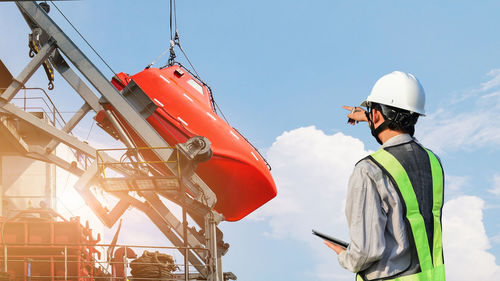 Low angle view of man working at construction site