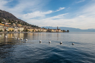 The beautiful lakeside of salò with the lake garda and the monte baldo in background