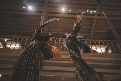 Low angle view of illuminated lighting equipment in museum