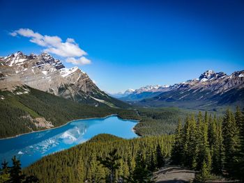 Scenic view of snowcapped mountains against blue sky