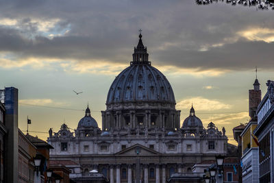 View of st. peter's basilica against sky at sunset