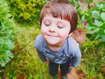 Close-up of cute boy standing on field