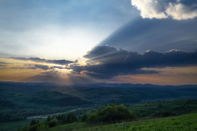 Scenic view of field against sky during sunset