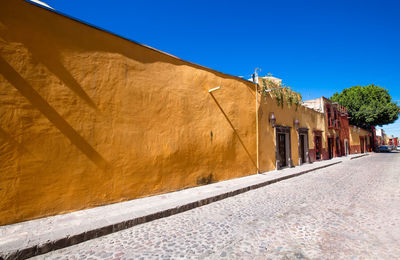 Street by building against clear sky