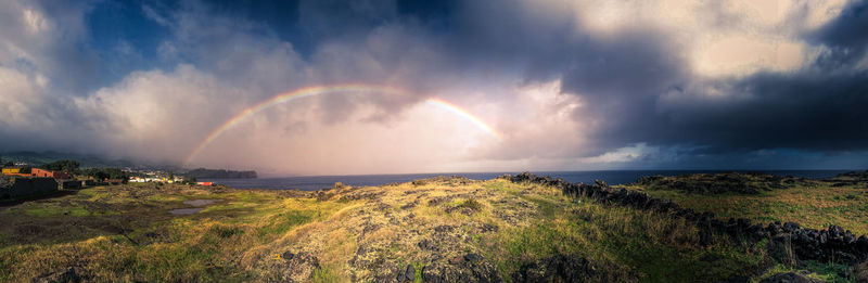 Panoramic view of rainbow over sea against sky