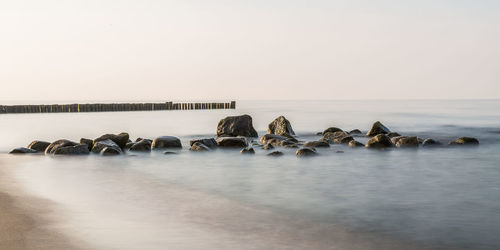 Rocks at sea against sky