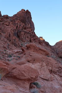 Low angle view of rock formations against clear sky