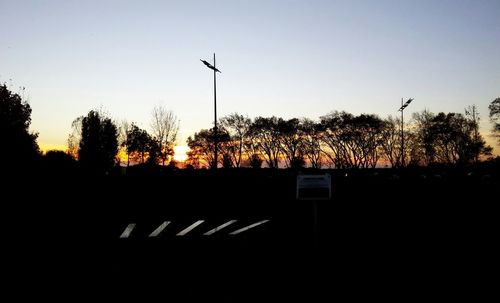 Silhouette of trees against sky at sunset