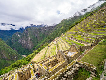 Aerial view of mountain range against cloudy sky