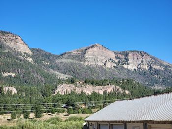 Scenic view of mountains against clear blue sky