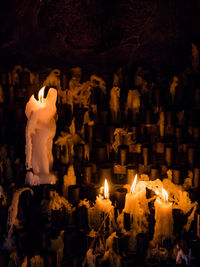 High angle view of burning candles in darkroom