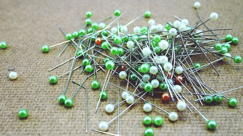 A white, green peg on a wooden floor.