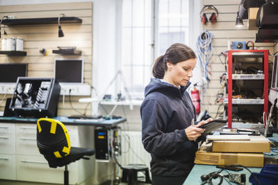 Engineer holding digital tablet in computer store