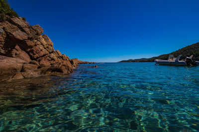 Scenic view of sea against clear blue sky