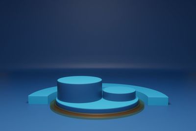 Close-up of illuminated lamp on table against blue background