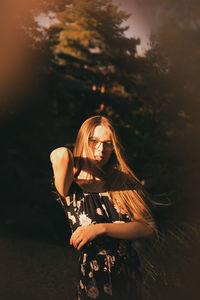 Portrait of young woman standing outdoors